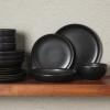 imageGibson Elite Island Cove 16 Piece Service for 4 Plates and Bowls Reactive Glaze Organic Round Dishes Stoneware Ceramic Dinnerware Set GreenBeckett Black