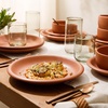 image:imageBloomhouse  Two Time Oprahs Favorite Things Winner  Corsica Clay 12 Piece Stoneware Rustic Reactive Glaze Dinnerware Set  Stackable Plates and Bowls Set Service for 4  Matte Sea Salt WhiteBurnt Apricot Terracotta