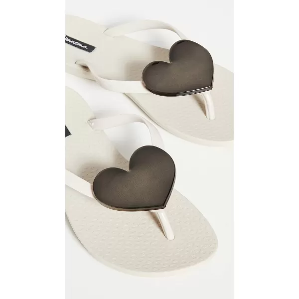 imageIpanema Womens Wave Heart Flip Flop  Comfortable amp Stylish Summer Sandal with Metallic Heart Embellishment Anatomic Footbed amp NonSlip SoleBeigeBeigeBlack