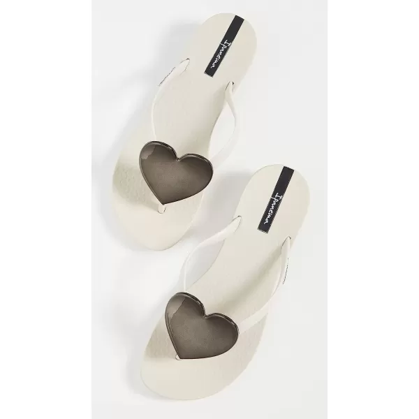 imageIpanema Womens Wave Heart Flip Flop  Comfortable amp Stylish Summer Sandal with Metallic Heart Embellishment Anatomic Footbed amp NonSlip SoleBeigeBeigeBlack