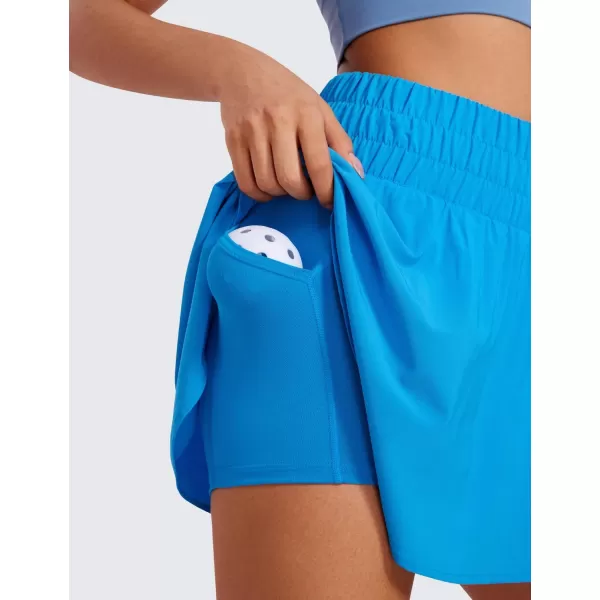 CRZ YOGA High Waisted Flowy Tennis Skirts for Women Pleated Casual Golf Athletic Pickleball Skorts with Shorts PocketsMadagascar Blue