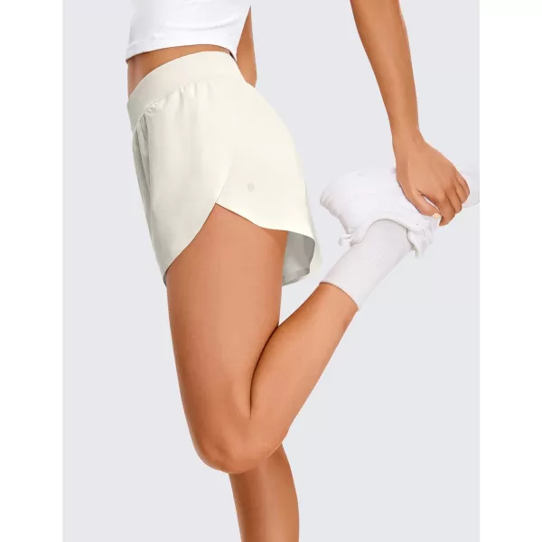 CRZ YOGA Mid Waisted Dolphin Athletic Shorts for Women Lightweight High Split Gym Workout Shorts with Liner Quick DryMilky White