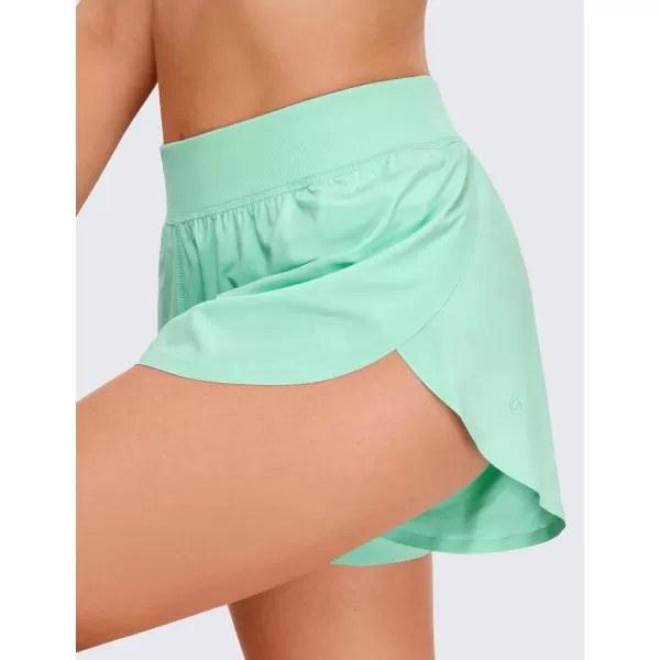 CRZ YOGA Mid Waisted Dolphin Athletic Shorts for Women Lightweight High Split Gym Workout Shorts with Liner Quick DryMint Moment