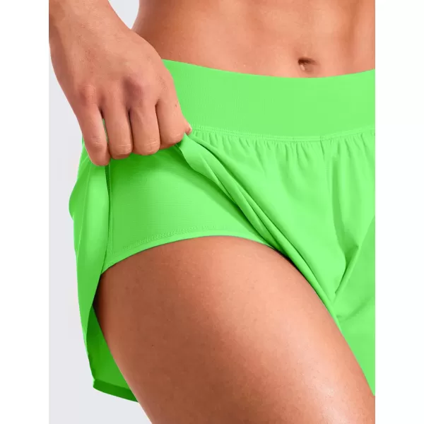 CRZ YOGA Mid Waisted Dolphin Athletic Shorts for Women Lightweight High Split Gym Workout Shorts with Liner Quick DryNeon Apple Green