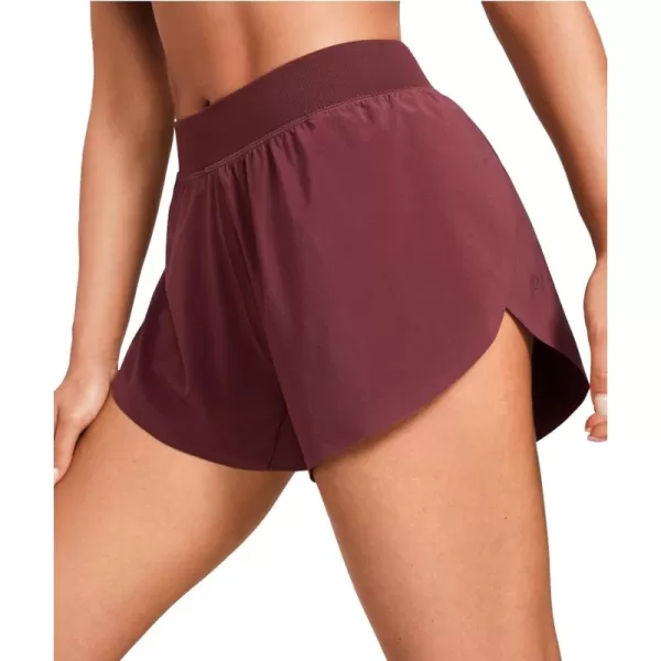 CRZ YOGA Mid Waisted Dolphin Athletic Shorts for Women Lightweight High Split Gym Workout Shorts with Liner Quick DryRed Merlot