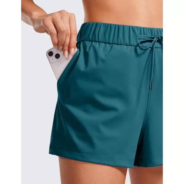 CRZ YOGA Stretch Shorts for Women Work Casual 25  Athletic Shorts with Pockets for Workout Travel Hiking GolfBorealis Green