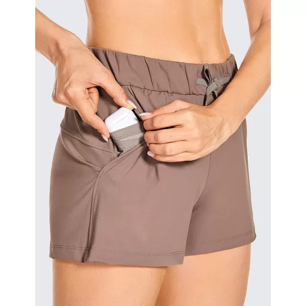 CRZ YOGA Stretch Shorts for Women Work Casual 25  Athletic Shorts with Pockets for Workout Travel Hiking GolfMineral Brown