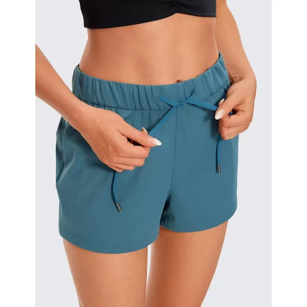 CRZ YOGA Stretch Shorts for Women Work Casual 25  Athletic Shorts with Pockets for Workout Travel Hiking GolfPetrol Blue