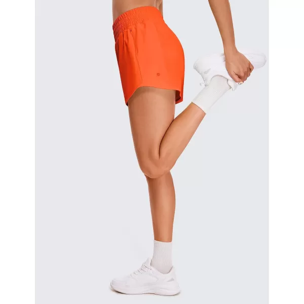 CRZ YOGA Womens High Waisted Running Shorts 4  Mesh Liner Lightweight Gym Sport Athletic Workout Shorts with Zipper PocketNeon Orange