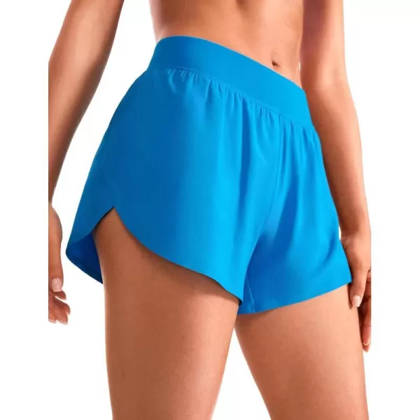 CRZ YOGA Mid Waisted Dolphin Athletic Shorts for Women Lightweight High Split Gym Workout Shorts with Liner Quick DryMadagascar Blue