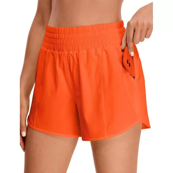 CRZ YOGA Womens High Waisted Running Shorts 4  Mesh Liner Lightweight Gym Sport Athletic Workout Shorts with Zipper PocketNeon Orange