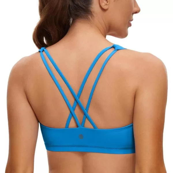 CRZ YOGA Womens Low Impact Strappy Sports Bra  Low Cut Wirefree Padded Yoga Bra Criss Cross BackMadagascar Blue