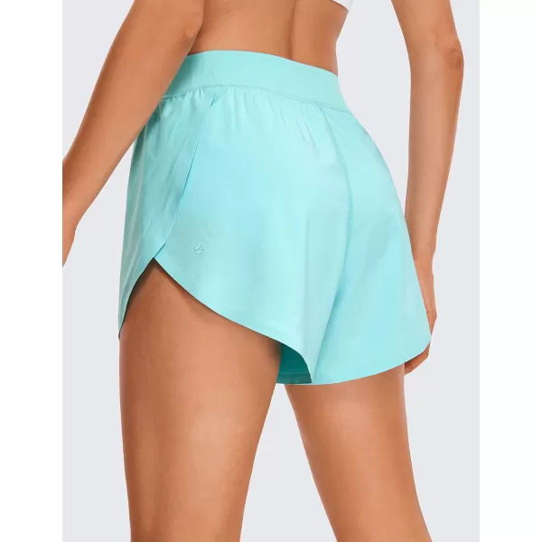 CRZ YOGA Mid Waisted Dolphin Athletic Running Shorts for Women Lightweight High Split Gym Workout Shorts with Liner Quick DryTurquoise