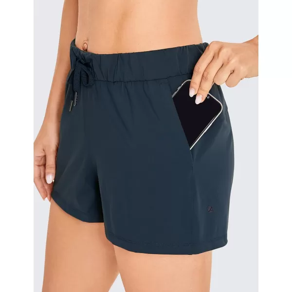 CRZ YOGA Stretch Shorts for Women Casual Work  Athletic Shorts with Pockets Travel Workout Hiking Golf Running Shorts25 inches True Navy