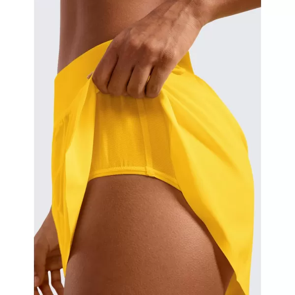 CRZ YOGA Mid Waisted Dolphin Athletic Shorts for Women 4quot Lightweight High Split Gym Workout Shorts with Liner Quick DryHigh Visibility Yellow