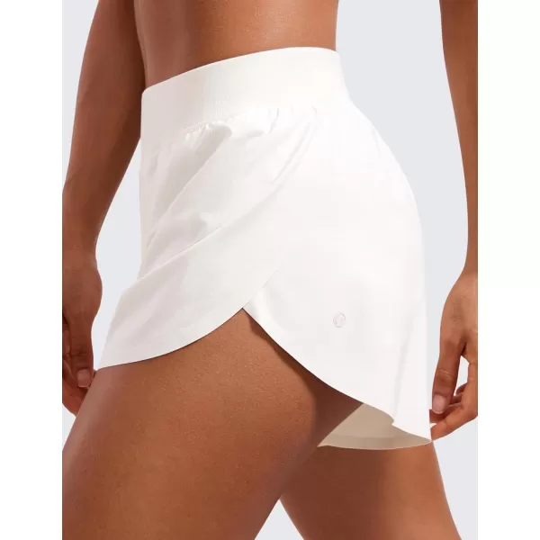 CRZ YOGA Mid Waisted Dolphin Athletic Shorts for Women 4quot Lightweight High Split Gym Workout Shorts with Liner Quick DryMilky White Bone