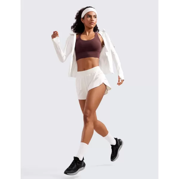 CRZ YOGA Mid Waisted Dolphin Athletic Shorts for Women 4quot Lightweight High Split Gym Workout Shorts with Liner Quick DryMilky White Bone