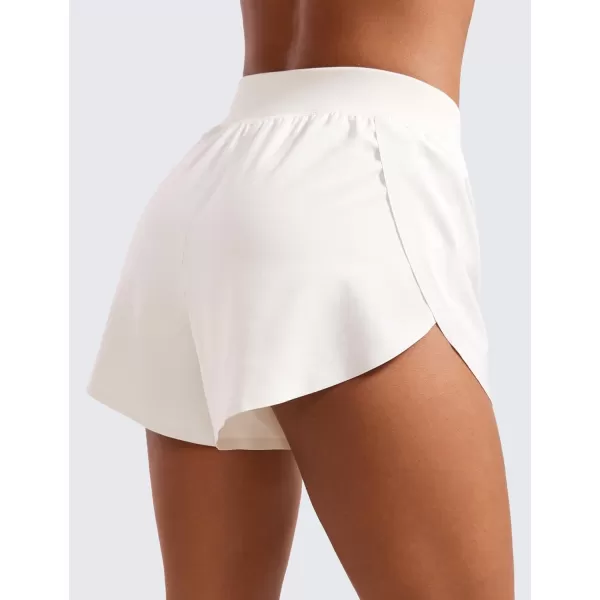 CRZ YOGA Mid Waisted Dolphin Athletic Shorts for Women 4quot Lightweight High Split Gym Workout Shorts with Liner Quick DryMilky White Bone