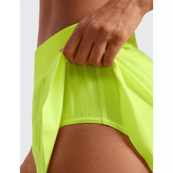 CRZ YOGA Mid Waisted Dolphin Athletic Shorts for Women 4quot Lightweight High Split Gym Workout Shorts with Liner Quick DryNeon Yellow