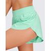 imageCRZ YOGA Mid Waisted Dolphin Athletic Shorts for Women 4quot Lightweight High Split for Gym Workout with Liner Quick DryMint Moment