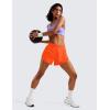 imageCRZ YOGA Mid Waisted Dolphin Athletic Shorts for Women 4quot Lightweight High Split for Gym Workout with Liner Quick DryNeon Orange