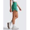 imageCRZ YOGA Dolphin Golf Skirts for Women A Line High Waisted Casual Athletic Mini Tennis Pickleball Skort with Zipper PocketCascadia Green