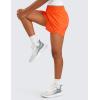 imageCRZ YOGA Girls Athletic Shorts with Zipper Pocket for Teens Kids Running Workout Casual Tennis Soccer Lightweight LinerNeon Orange