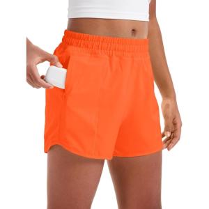 imageCRZ YOGA Girls Athletic Shorts with Zipper Pocket for Teens Kids Running Workout Casual Tennis Soccer Lightweight LinerNeon Orange