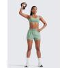 imageCRZ YOGA Mid Waisted Running Shorts for Women 3quot Curved Hems for Athletic Workout Gym with Zipper Pockets LineGreen Palm Court