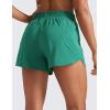 imageCRZ YOGA Womens High Waisted Running Shorts Mesh Liner 3 Dolphin Quick Dry for Athletic Gym Track Workout with Zip PocketCascadia Green